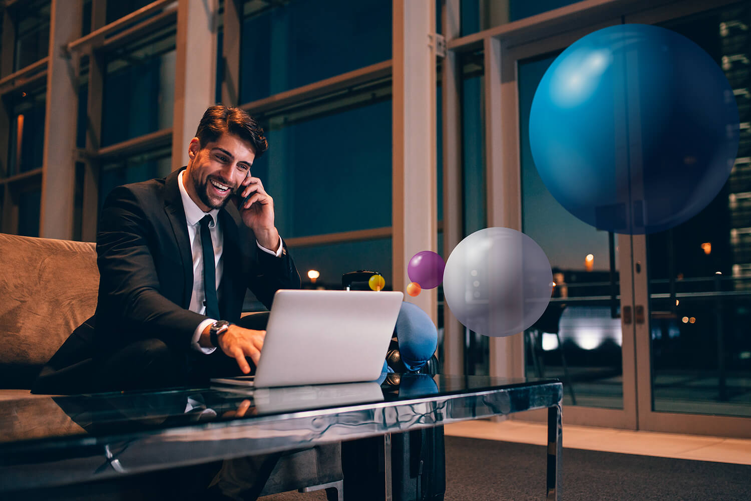 a businessman talking on his phone and using his laptop at the same time.