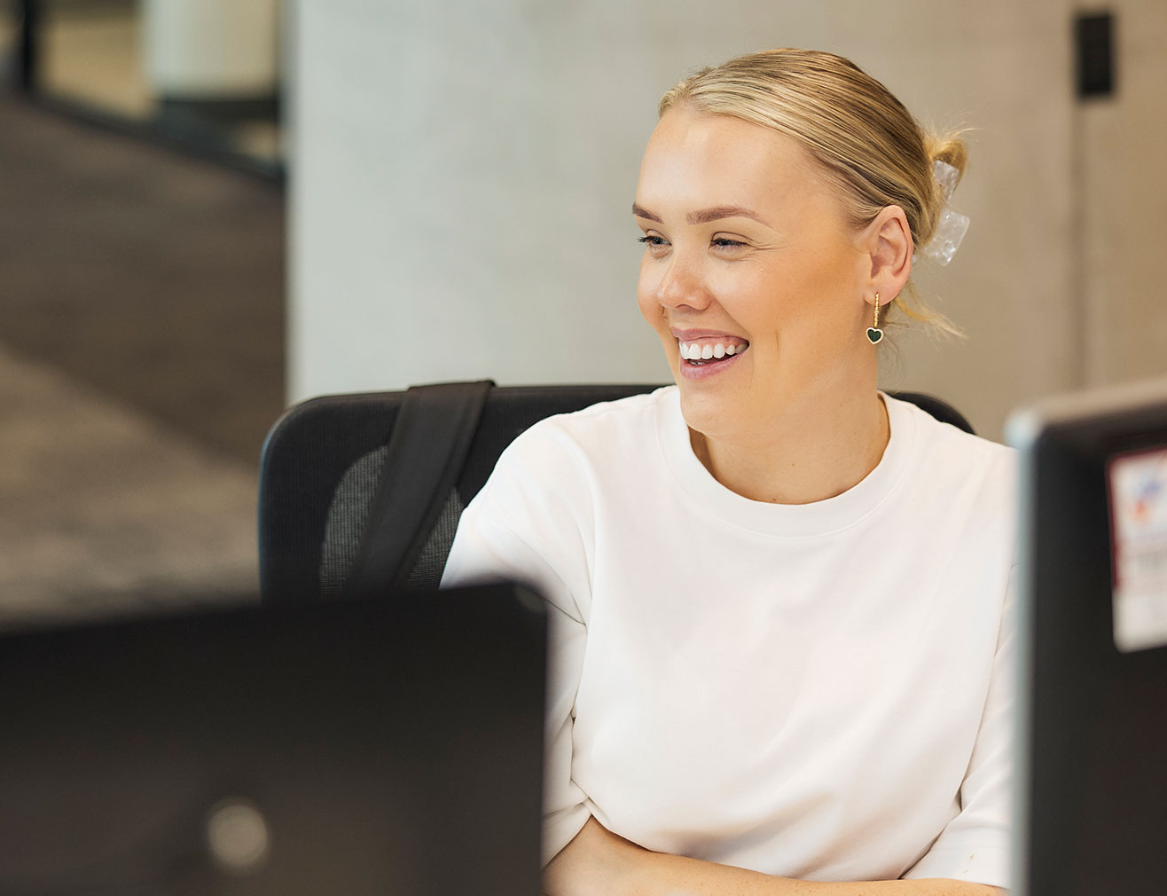 An employee infront of a desktop